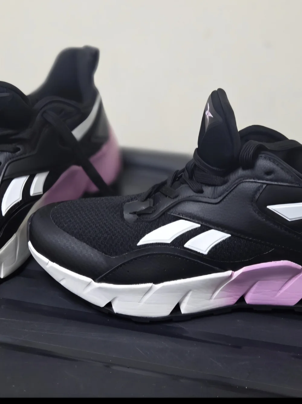 Reebok Black Athletic Sneakers with White Stripes and Pink Logo